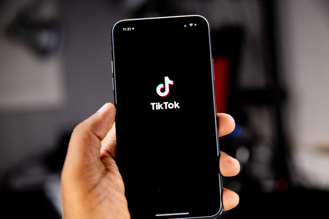 Person holding smartphone with TikTok app open